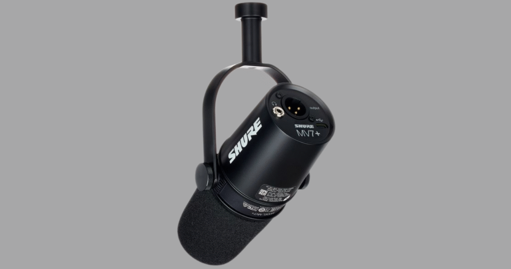 Detalhe das conexões híbridas do microfone Shure MV7, exibindo claramente as saídas USB e XLR e a entrada para fone de ouvido, que oferecem flexibilidade para iniciantes e profissionais.