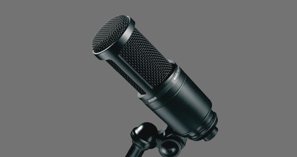 Setup de gravação de voz com o microfone Audio-Technica AT2020 equipado com um pop filter e um shock mount pretos.